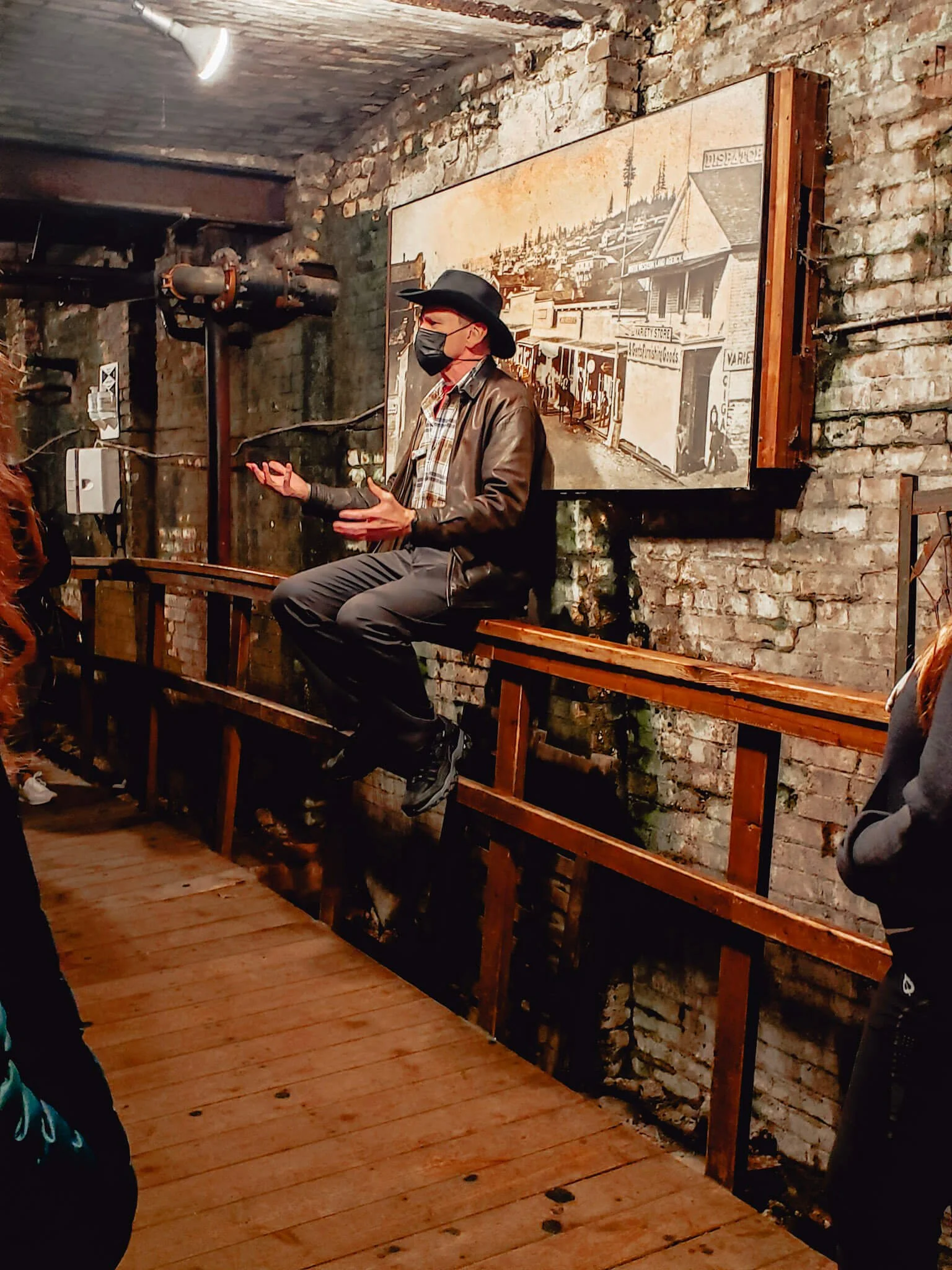 Seattle Underground Tour guide in historic brick tunnel Pioneer Square